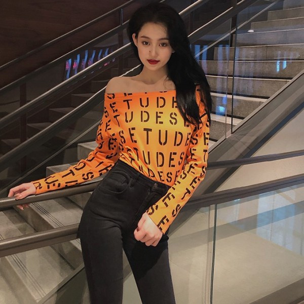 Női testhezálló blúz fekete, fehér és narancssárga feliratokkal