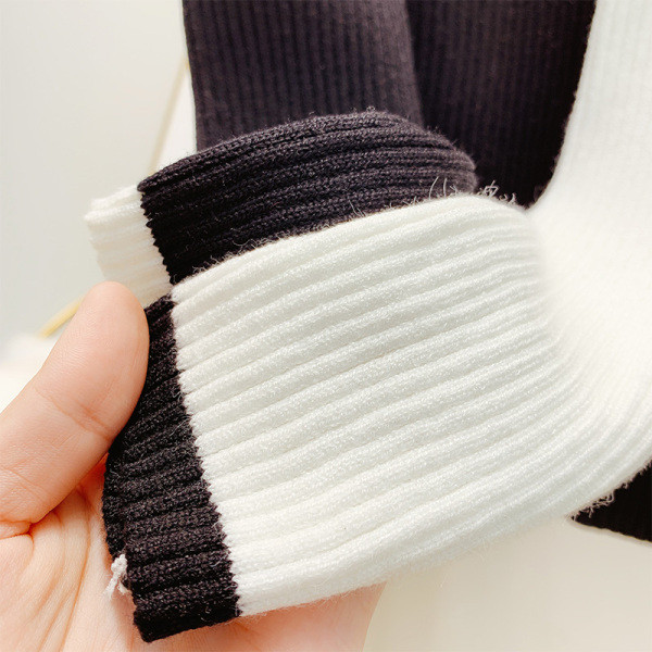 Vékony kötésből készült női pulóver puffos ujjakkal, fehér és fekete színben