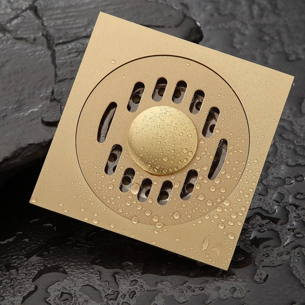 Sifon de podea de cupru de 10 cm potrivit pentru o baie patrata in culoarea aurie