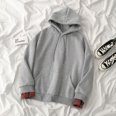 Női pulóver fekete, fehér és szürke színben kapucnival és nyakkendővel