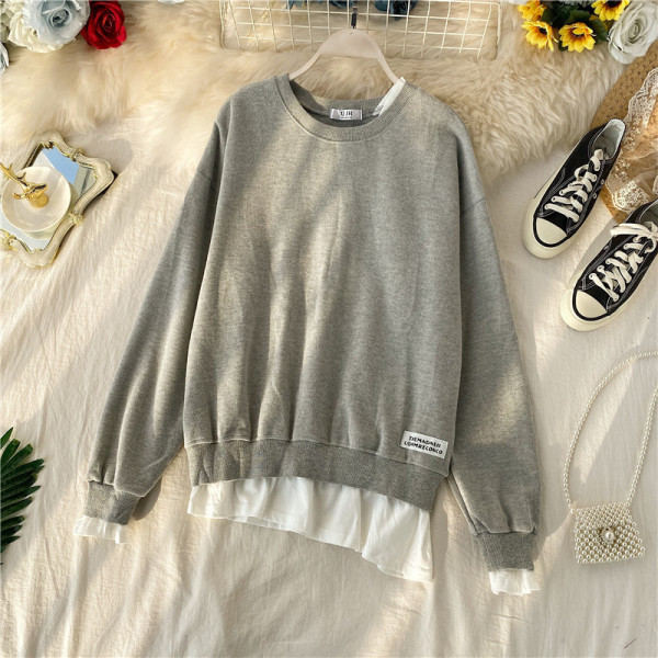 Μοντέρνο πουλόβερ  με ωοειδές λαιμόκοκκο και ασύμμετρο μοτίβο με μακρύ μανίκι