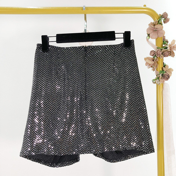 Модерна къса пола асиметричен модел в черен цвят с лъскав ефект