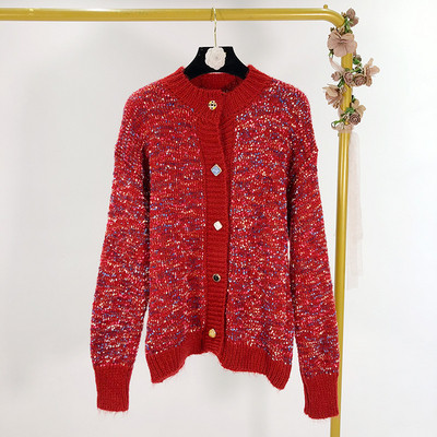 Vesta de dama tricotata cu nasturi de diferite culori in doua culori