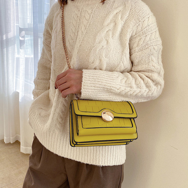 Női bőrtáska lánccal és fém csattal