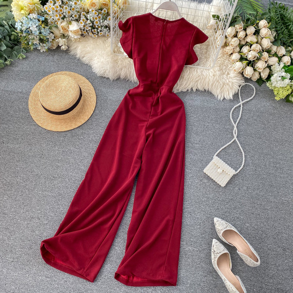 Női hosszú jumpsuit övvel és V-nyakú bordó, kék, zöld, fekete és szürke színekben