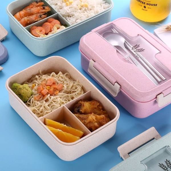 Plastic food box with three compartments and lid with storage space for utensils in green, pink, beige and blue
