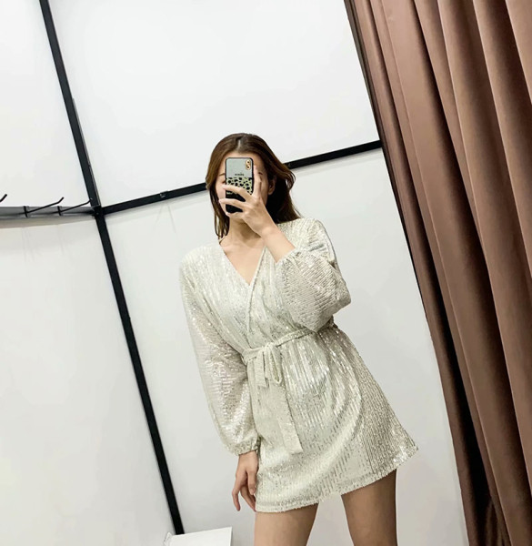 Modern női ruha mély nyakkivágással, szürke övvel, flitterekkel