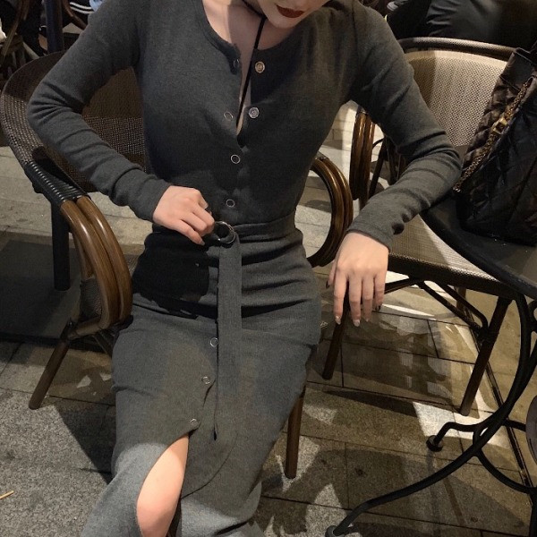 Szürke színű, testhezálló aszimmetrikus ruha gombokkal és övvel