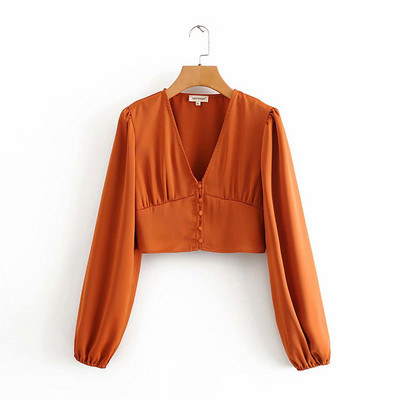 Rövid női blúz V-nyakkal és narancssárga gombokkal