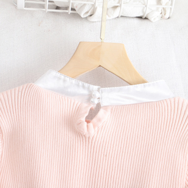 Rózsaszín, fehér és fekete női pulóver szalaggal és lótusz ujjal