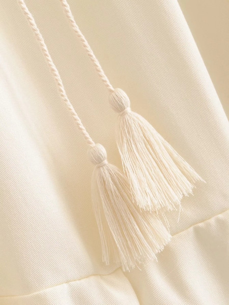 Női felső kivágású modell vékony pántokkal és fürtökkel, bézs színben