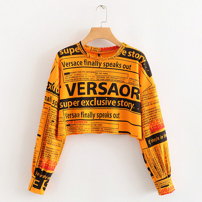 Modern rövid blúz, hosszú ujjú zöld, narancssárga és fehér feliratokkal