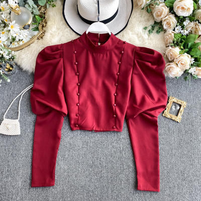 Stílusos rövid női blúz puffos ujjakkal és gombokkal bordó, fekete, fehér és bézs színben