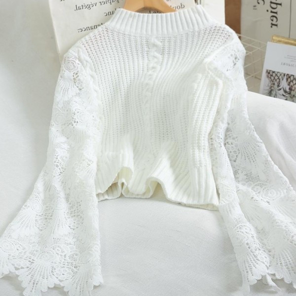 Modern női pulóver ovális nyakkivágással, fehér és fekete hímzéssel