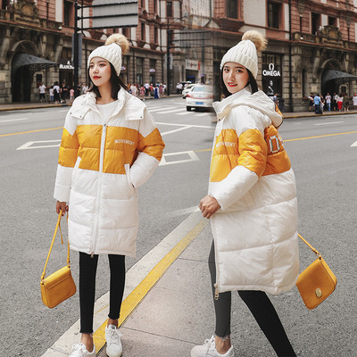 Modern női kabát hosszú modell kapucnival fekete, sárga és fehér színekben