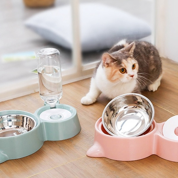 Food bowl in the shape of a cat`s head and a water dispenser in gray, pink and green