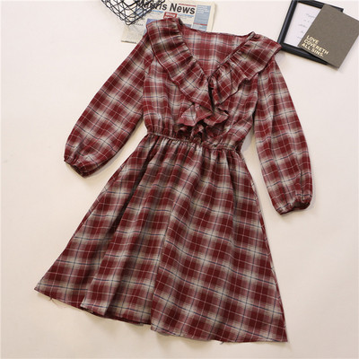 Fekete, narancssárga és piros kockás női ruha fürtökkel és hosszú ujjakkal