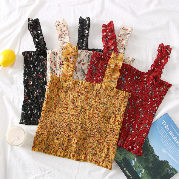 Új modell női felső pántokkal és virágmotívumokkal