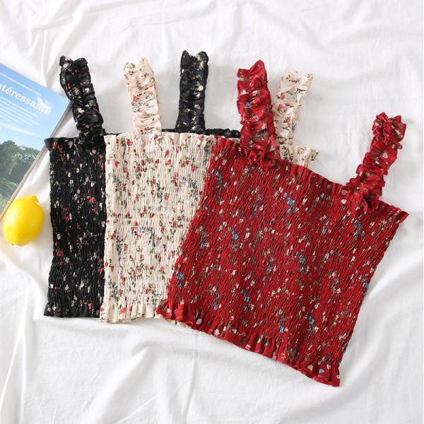 Új modell női felső pántokkal és virágmotívumokkal