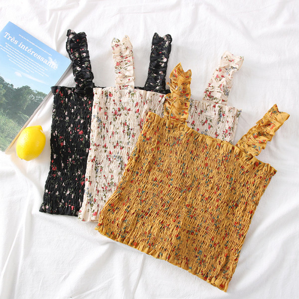 Új modell női felső pántokkal és virágmotívumokkal