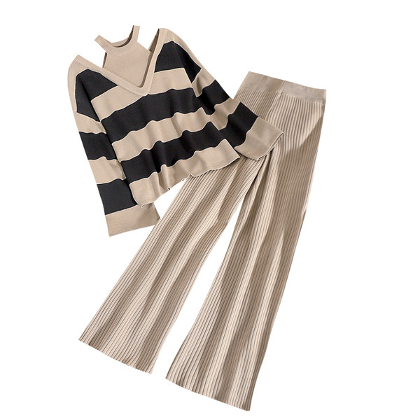 Modern női szett, amely egy csupasz vállú pulóvert és magas derékú, redőzött nadrágot tartalmaz