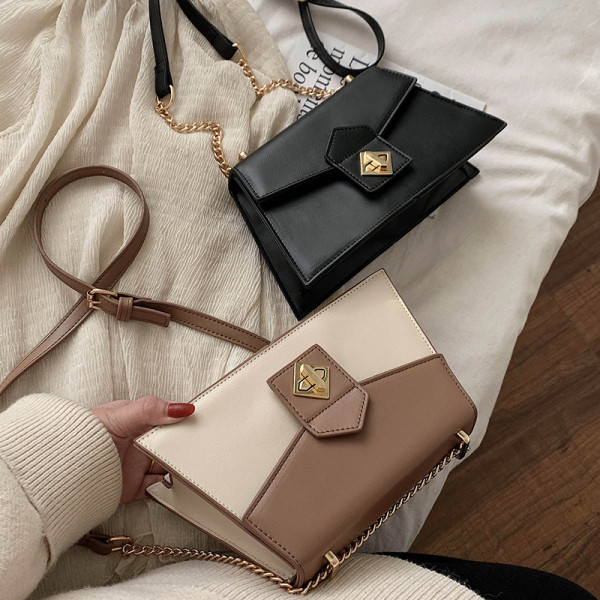 Modern női táska fém rögzítéssel és hosszú fogantyúval