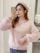 Női pehely pulóver rojtokkal és fürtökkel