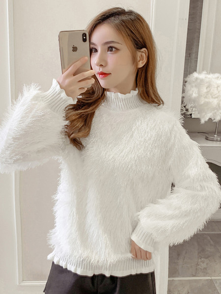 Női pehely pulóver rojtokkal és fürtökkel