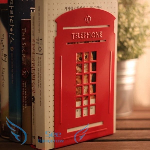 Metal stand for magazines and books in the form of a telephone booth